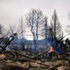 A fire still burns in a home destroyed by the Marshall Wildfire in Louisville, Colo., Friday, Dec. 31, 2021.